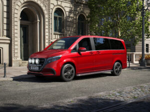 Photorealistic product CGI of a red van parked in front of a city apartment building, showcasing detailed materials and realism, created by Nordic Render.