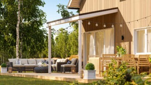 Photorealistic 3D visualization of a wooden house terrace with outdoor seating area in summer, surrounded by trees, created by Nordic Render.